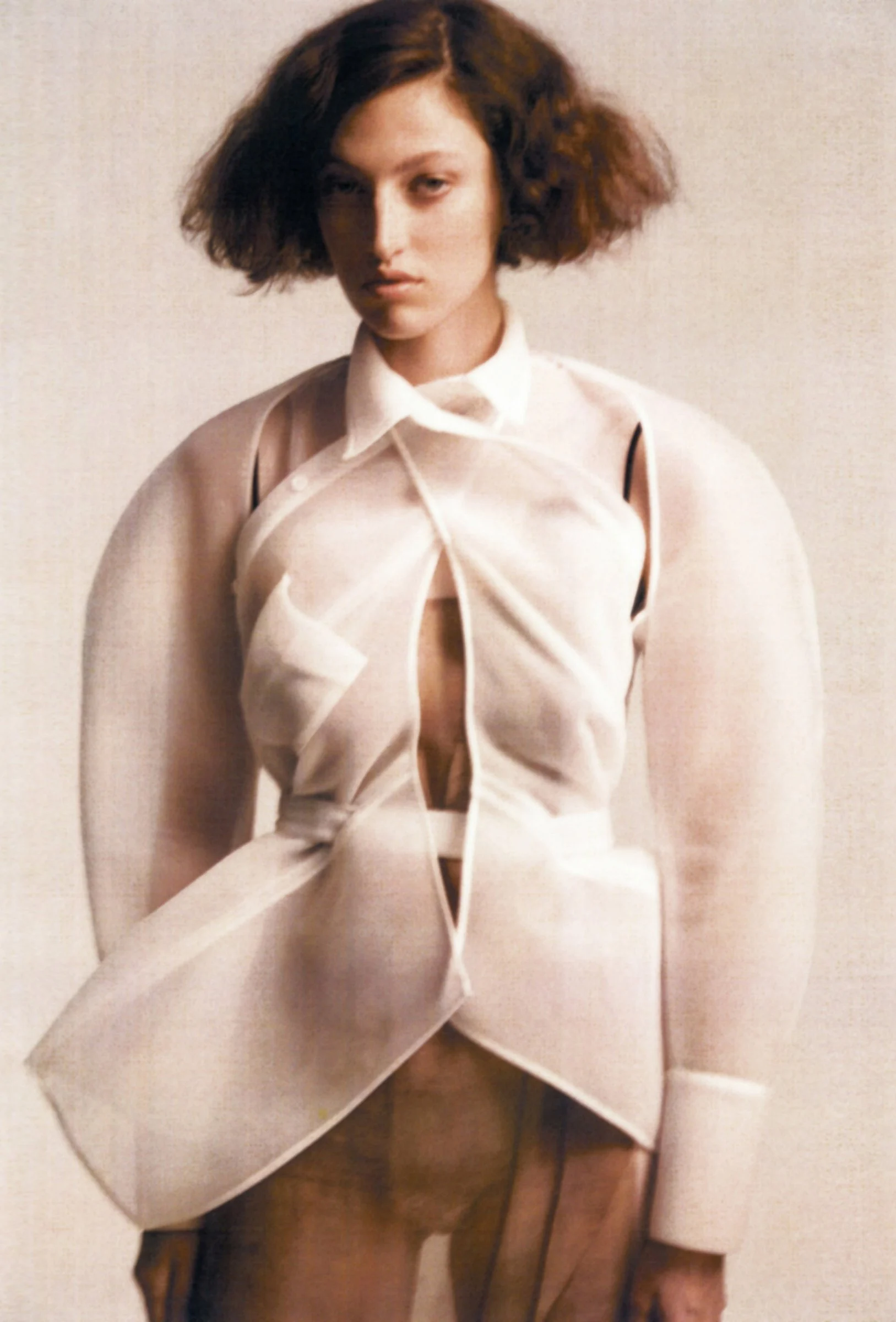 A model in a sculptural cream jacket, photographed by Hanna Tveite
