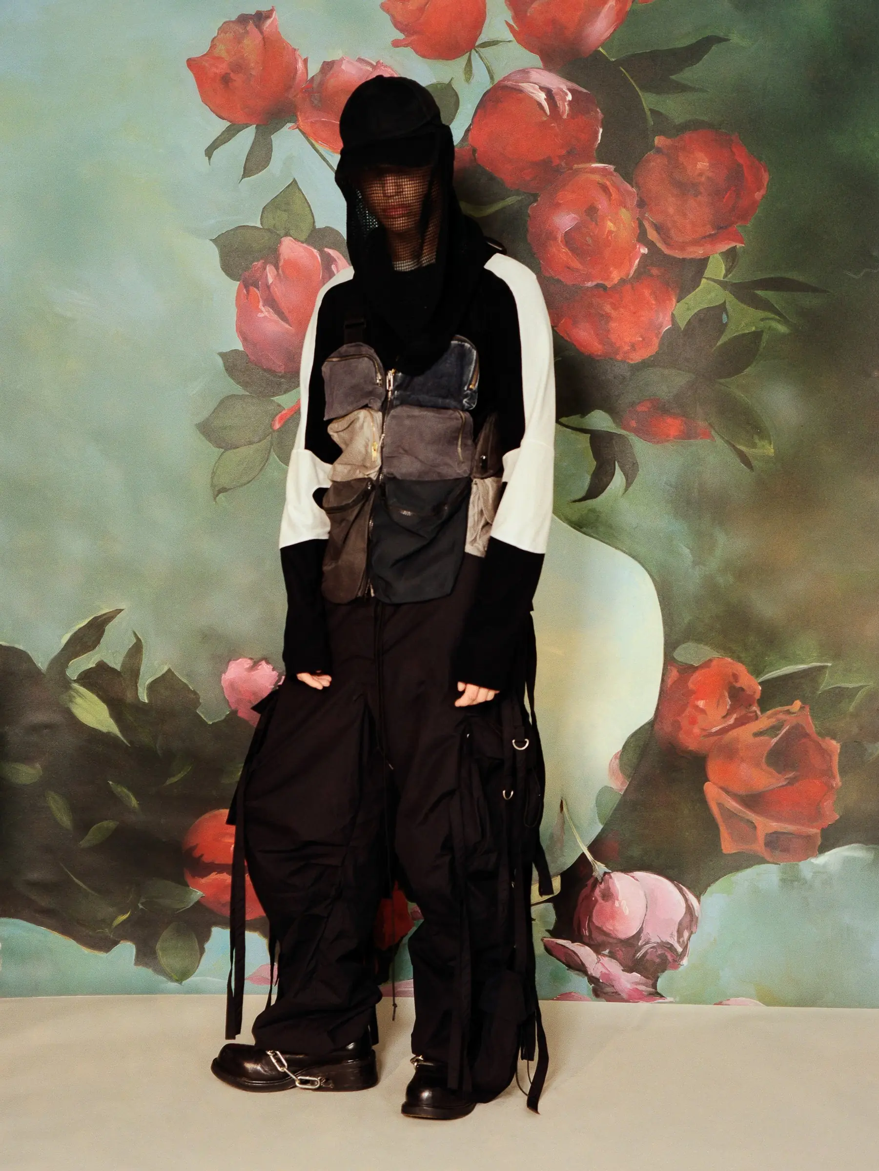 Office, 2020: a model in black in front of a painted rose backdrop